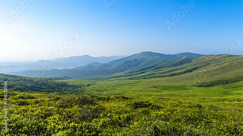 Distant Mountain Range Over Lush Green Valley