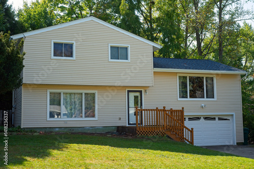 A split-level house with newly installed vinyl siding