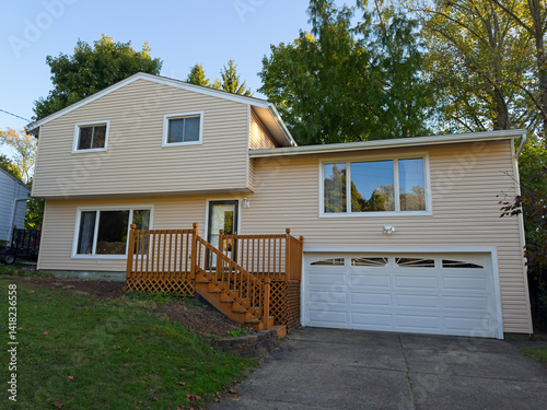 A split-level house with newly installed vinyl siding