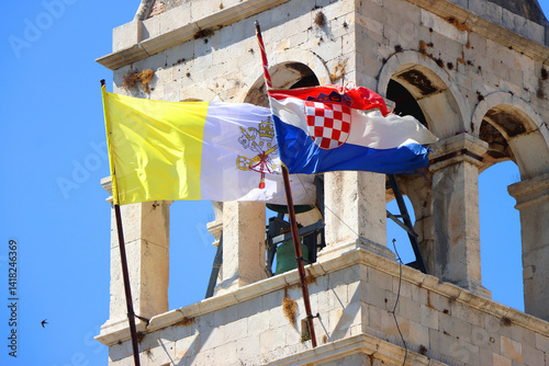 Obraz na płótnie Historical church and monastery of Saint Dominic, in Trogir, Croatia. Flags of Croatia and Vatican City on the tower. w salonie