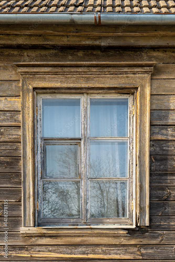 Close-Up of Weathered Wooden Window on an Old House in Latvia – Rustic Texture and Natural Reflection in Soft Spring Light Close-Up of Weathered Wooden Window on an Old House in Latvia – Rustic Texture and Natural Reflection in Soft Spring Light