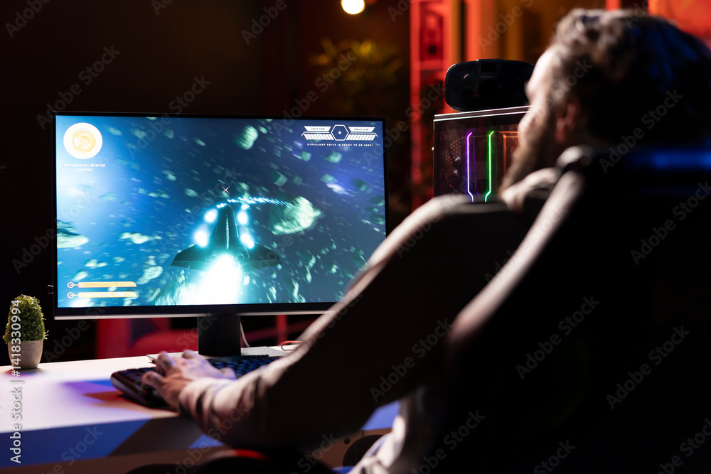 Man having fun shooting asteroids in spaceship flying game with overlay HUD showing health, fuel, ammo bars and minimap. Gamer navigating universe in simulation game, gaming on computer