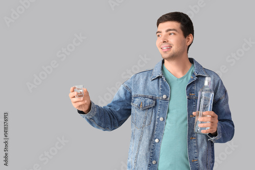 Young man with glass and bo...