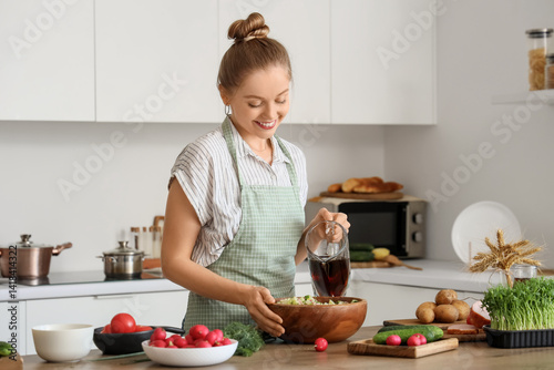Young woman pouring kvass i...