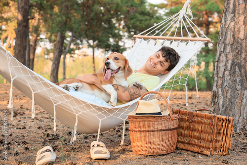 Young man with Beagle dog l...