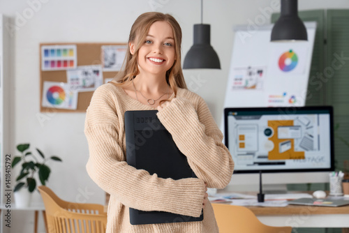 Female web designer with graphic tablet in office