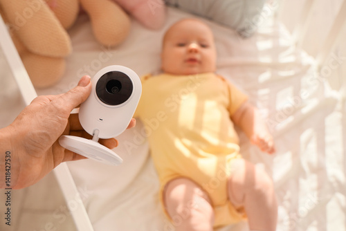 Mother holding baby monitor...