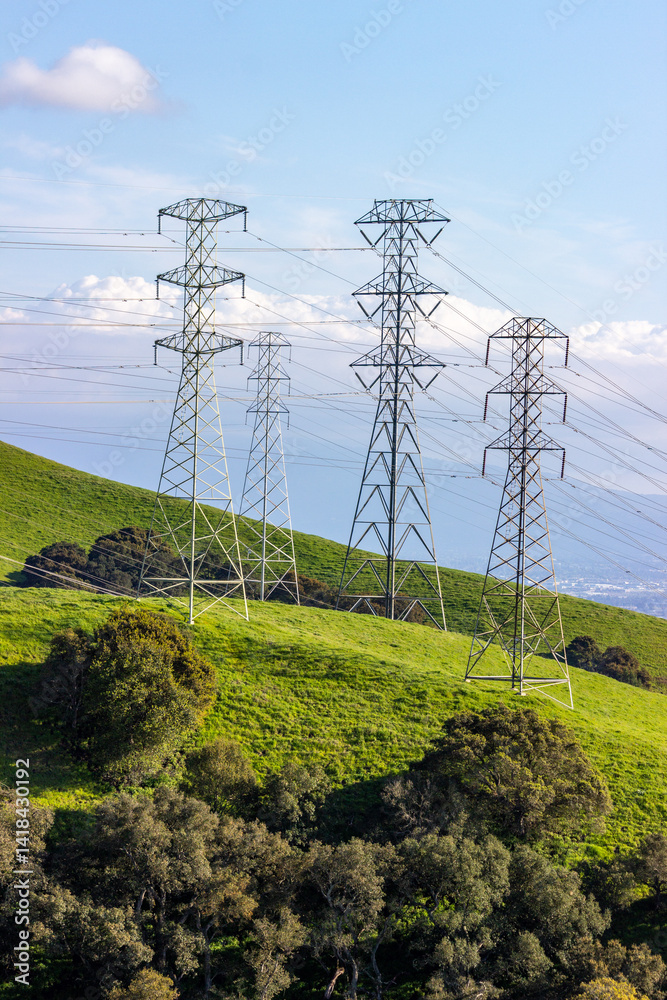 Rolling green hills with power lines stretching across the Bay Area landscape