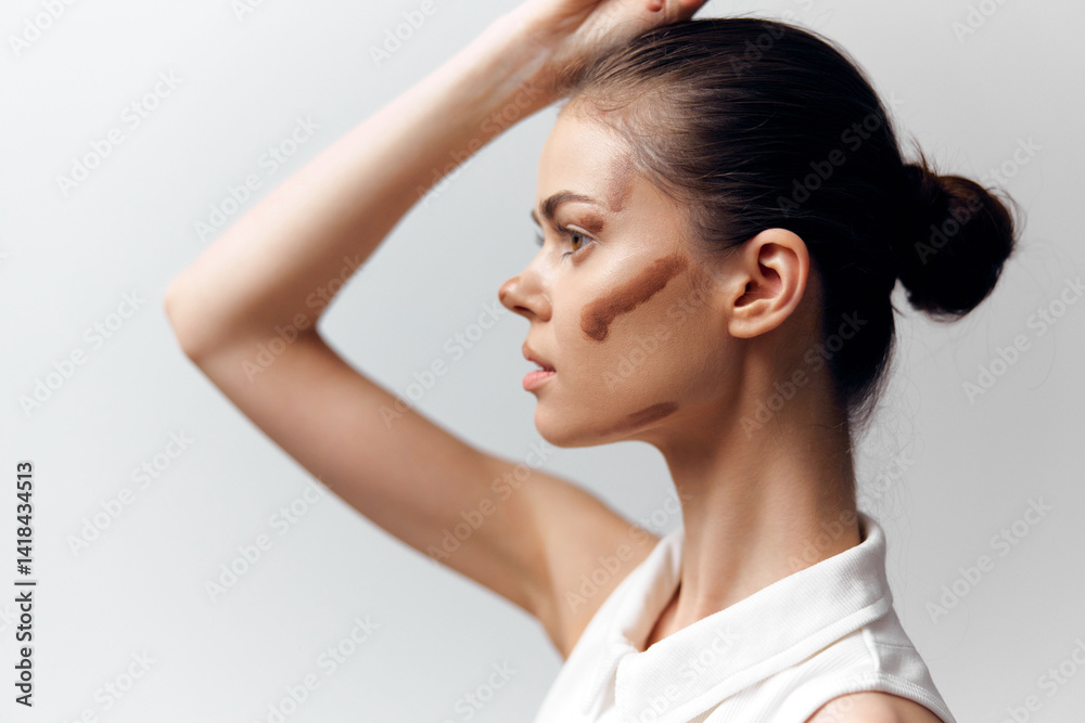 Profile portrait of a young woman showcasing artistic makeup with abstract patterns, neutral background emphasizing her features and elegance. Profile portrait of a young woman showcasing artistic makeup with abstract patterns, neutral background emphasizing her features and elegance.