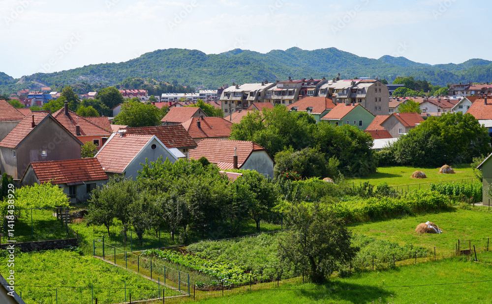 Aerial view of Cetinje, the former capital of Montenegro in the Balkans - Houses in a lush valley surrounded by the mountains of Eastern Europe