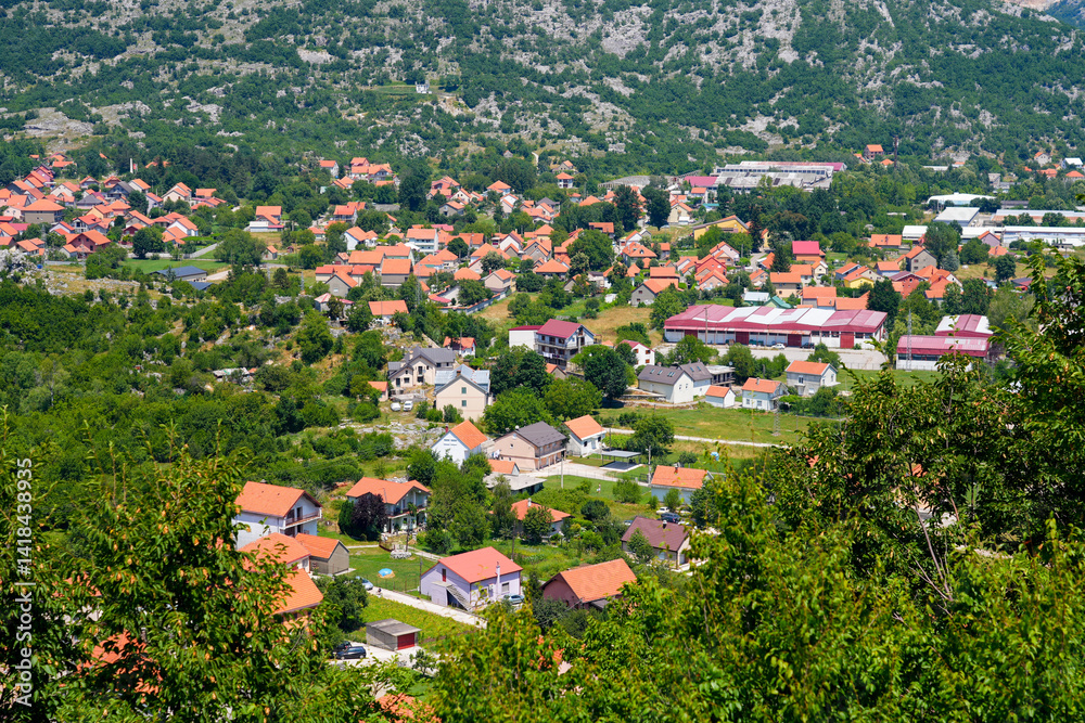 Aerial view of Cetinje, the former capital of Montenegro in the Balkans - Houses in a lush valley surrounded by the mountains of Eastern Europe