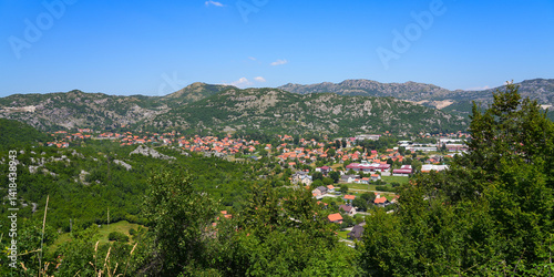 Obraz na płótnie Aerial view of Cetinje, the former capital of Montenegro in the Balkans - Houses in a lush valley surrounded by the mountains of Eastern Europe w salonie