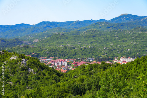 Obraz na płótnie Aerial view of Cetinje, the former capital of Montenegro in the Balkans - Houses in a lush valley surrounded by the mountains of Eastern Europe w salonie
