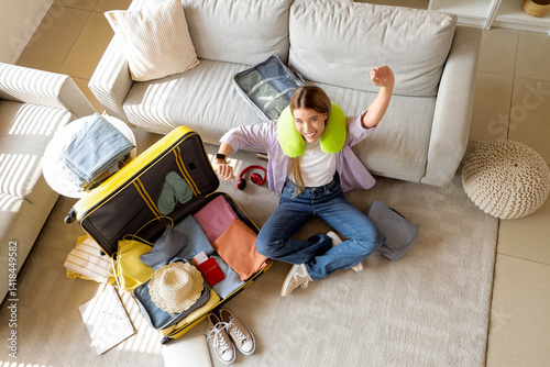 Happy female tourist packin...