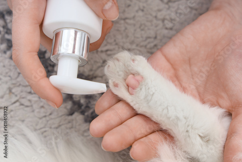 Female hands applying cream...