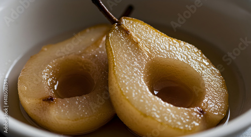Halved Poached Pears Served in Syrup Presenting a Refined Culinary Delight