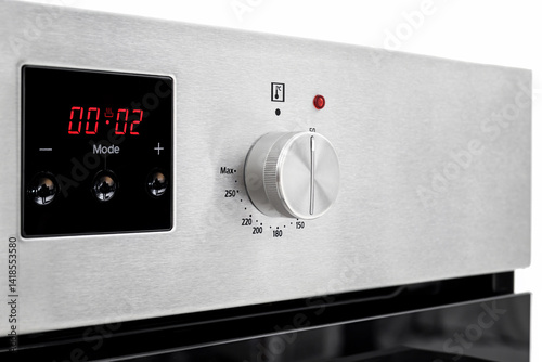 Metal control panel of electric oven with display and knob