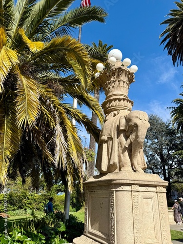 A whimsical elephant statue stands in a quiet outdoor area in Sausalito, California, surrounded by trees and coastal charm. Taken on April 10, 2025