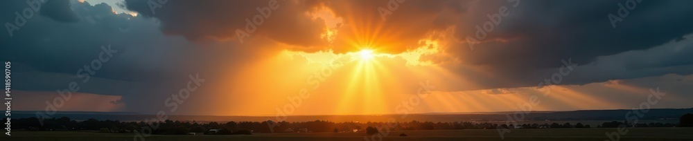 Fototapeta premium Golden rays pierce dark clouds, illuminating landscape, bright, warmth