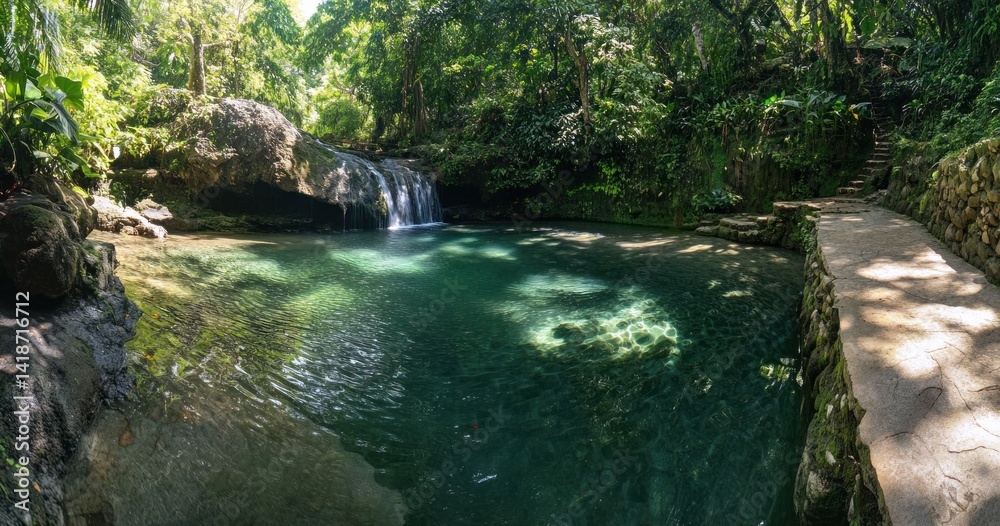 Naklejka premium Lush green scenery with flowing waterfall into clear pool of water