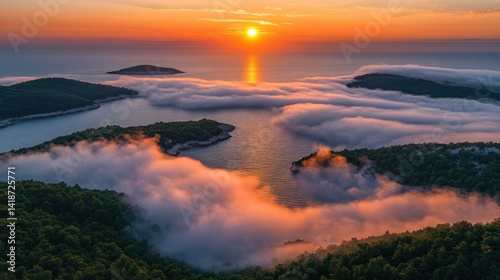 Breathtaking sunrise over a misty cove. Islands emerge from a sea of clouds.  Tranquil beauty at dawn