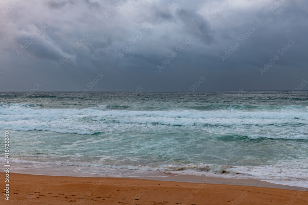 Moody sunrise with waves at the seaside Moody sunrise with waves at the seaside