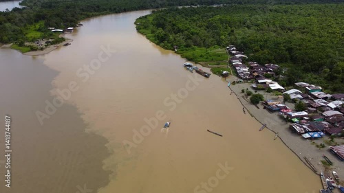Aerial Majesty of Quibdó: River, Faith, and Rainforest. Drone views of Quibdó, Choco, Colombia, featuring the Atrato River, boats, rainforest, and the iconic cathedral. A vibrant mix of nature.