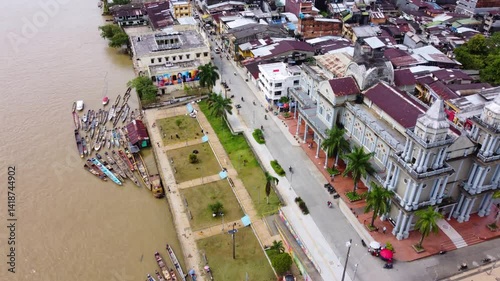 Aerial Majesty of Quibdó: River, Faith, and Rainforest. Drone views of Quibdó, Choco, Colombia, featuring the Atrato River, boats, rainforest, and the iconic cathedral. A vibrant mix of nature.