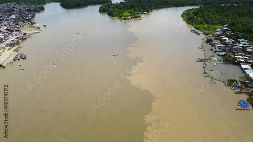 Aerial Majesty of Quibdó: River, Faith, and Rainforest. Drone views of Quibdó, Choco, Colombia, featuring the Atrato River, boats, rainforest, and the iconic cathedral. A vibrant mix of nature.