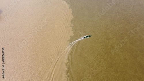 Aerial Majesty of Quibdó: River, Faith, and Rainforest. Drone views of Quibdó, Choco, Colombia, featuring the Atrato River, boats, rainforest, and the iconic cathedral. A vibrant mix of nature.