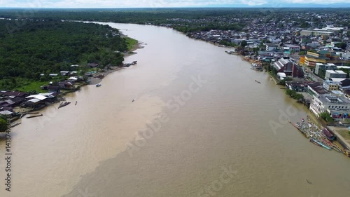 Aerial Majesty of Quibdó: River, Faith, and Rainforest. Drone views of Quibdó, Choco, Colombia, featuring the Atrato River, boats, rainforest, and the iconic cathedral. A vibrant mix of nature.