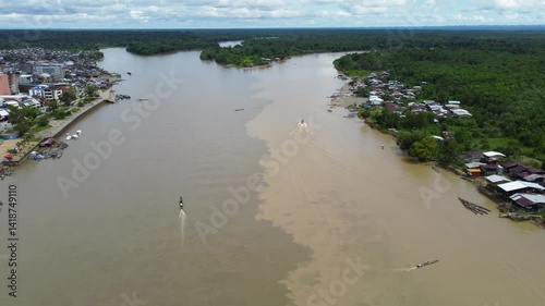 Aerial Majesty of Quibdó: River, Faith, and Rainforest. Drone views of Quibdó, Choco, Colombia, featuring the Atrato River, boats, rainforest, and the iconic cathedral. A vibrant mix of nature.