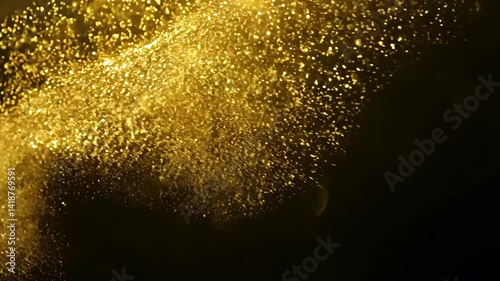Abstract background of gold particles. Gold dots back ground. gold dust and beautiful bokeh he and dark background. Seamless looping video Dynamic motion.