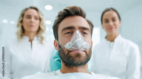 Obraz na płótnie A man receives care at a dental clinic wearing an oxygen mask with professionals nearby. w salonie