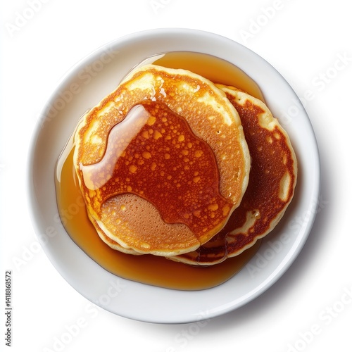 Two golden pancakes drizzled with syrup