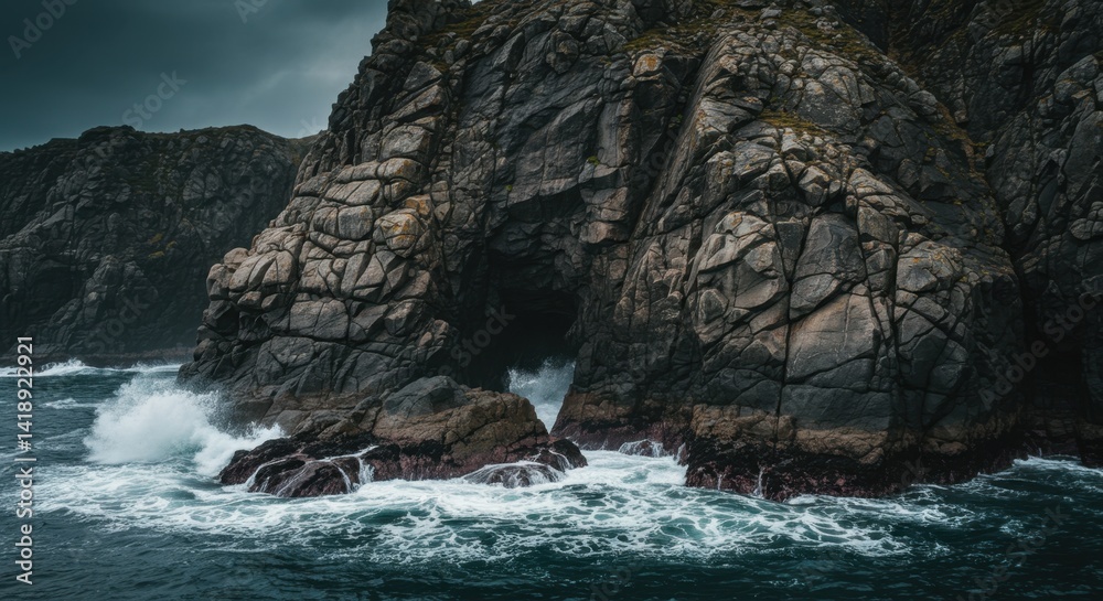 Obraz premium Dark Grey Rocks and Powerful Ocean Waves Crashing on Rugged Coast