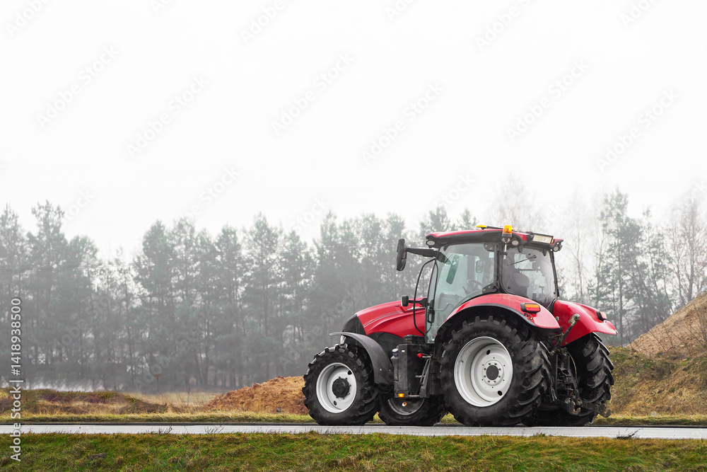 Tractor on foggy road in rural farming area