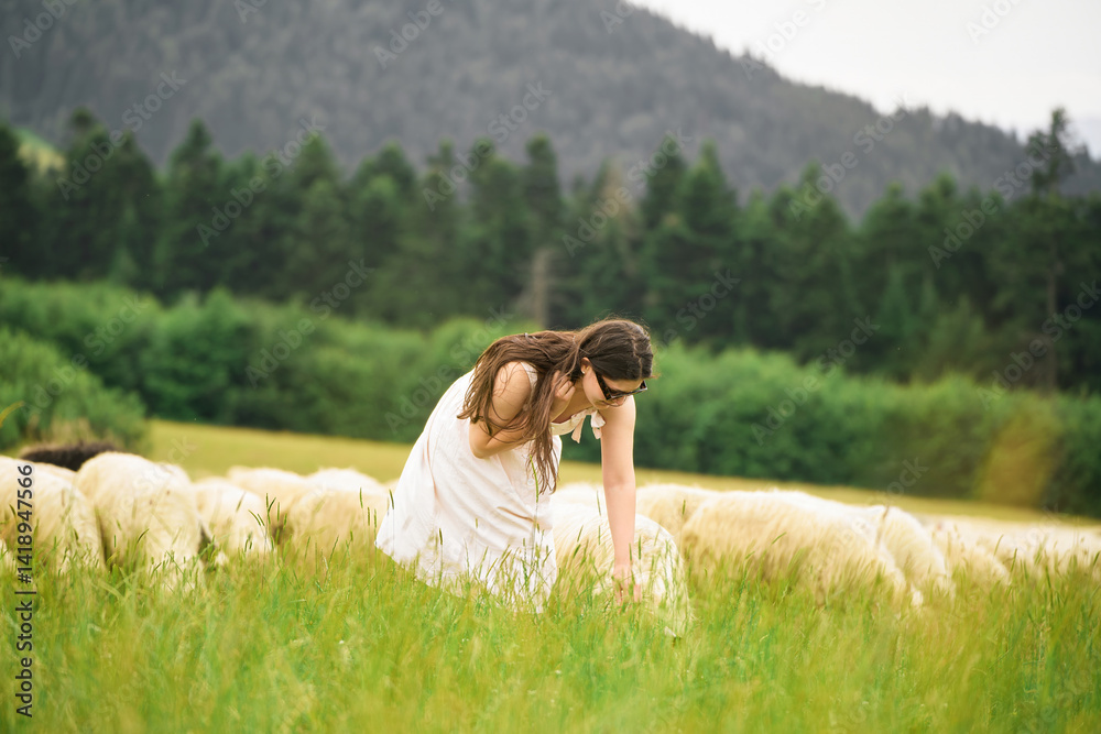 Girl in nature with sheeps her