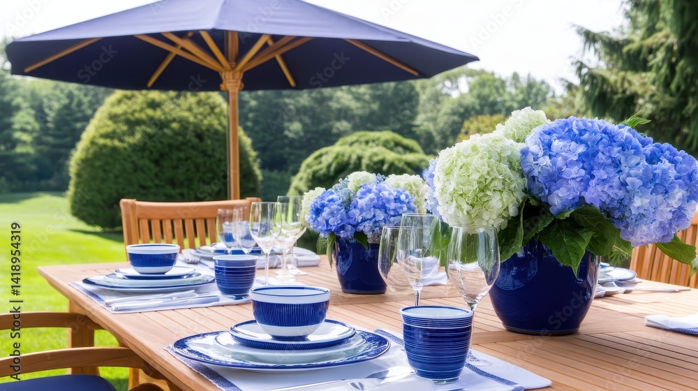 Fototapeta premium Elegant outdoor dining setup with blue and white tableware, surrounded by lush greenery and flowers