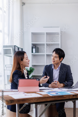 Team of financial advisory services. Asian advisor showing plan of investment to clients in the consultancy office.
