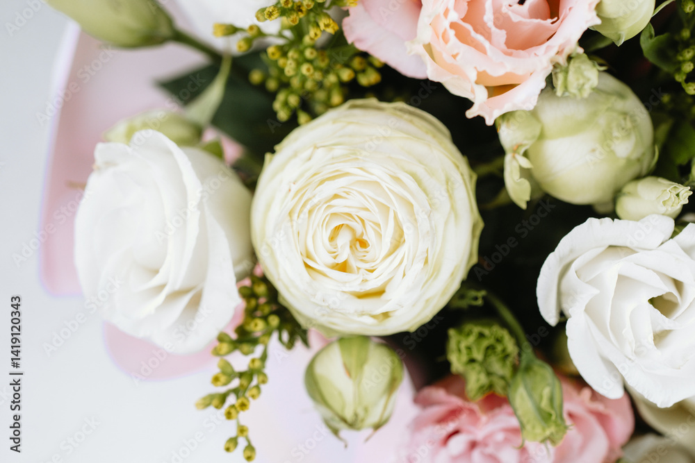 Fresh floral arrangement featuring roses and greenery in a soft color palette Fresh floral arrangement featuring roses and greenery in a soft color palette