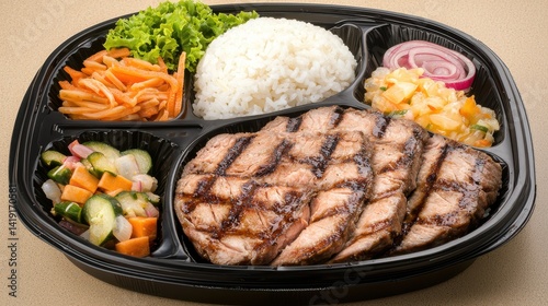 Delicious grilled chicken bento box closeup with rice and pickled vegetables indoor dining food photography