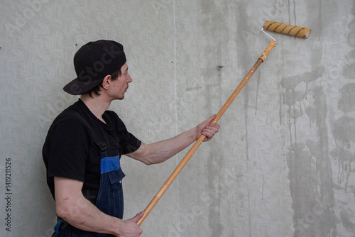 Painter wetting wallpaper with a roller (18)