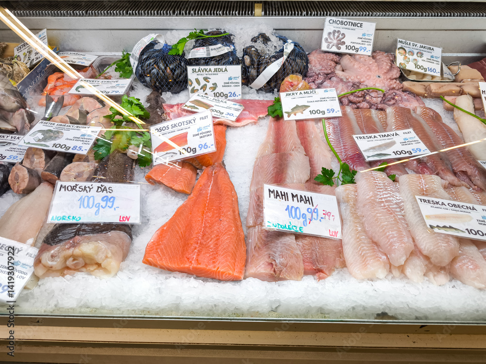 Fresh fish on ice at the Holesovice market displaying salmon, cod, octopus, and mussels in Prague, Czech republic