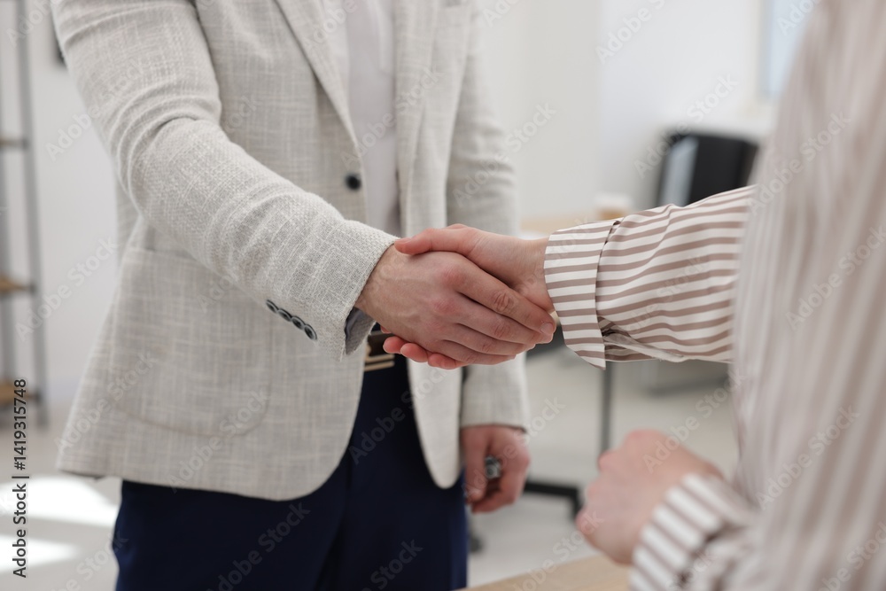 Fototapeta premium Recruiter and candidate shaking hands in office, closeup