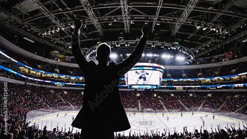 Enthusiastic fan celebrating in a thrilling ice hockey arena  