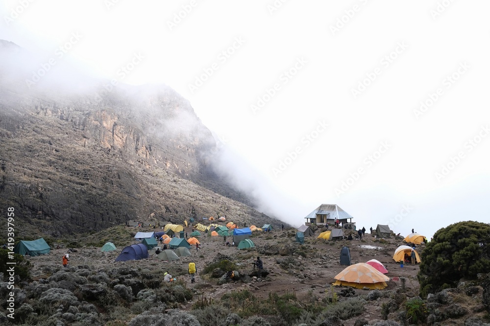 Misty scenery of Barranco Camp with tents on trail to Kilimanjaro Peak, Machame Route, Tanzania