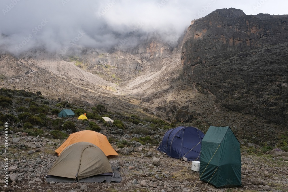 Misty scenery of Barranco Camp with tents on trail to Kilimanjaro Peak, Machame Route, Tanzania