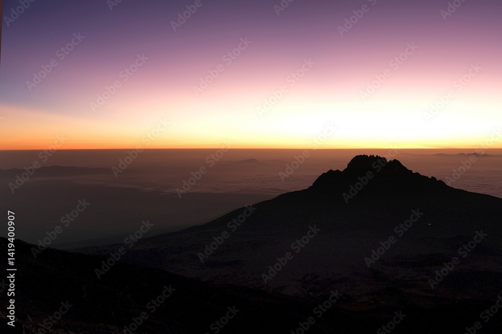 Sunset scenery with Mawenzi Peak on horizon during climbing to Uhuru peak on Kibo volcano (Kilimanjaro) – 5895 m. Tanzania