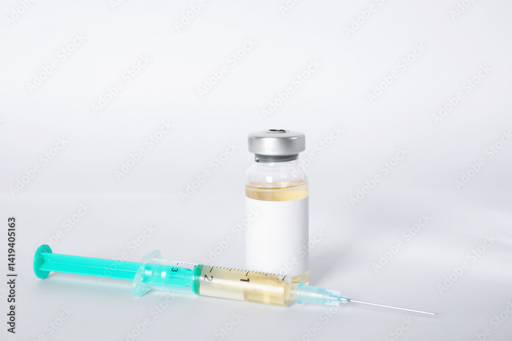 Hepatitis vaccine in glass vial and syringe on light background, closeup Hepatitis vaccine in glass vial and syringe on light background, closeup